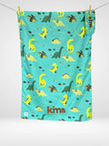 Serviette de plage enfant Kima Mesco Dino, turquoise à dinosaures, à plat - Ô Cabanon La Ciotat